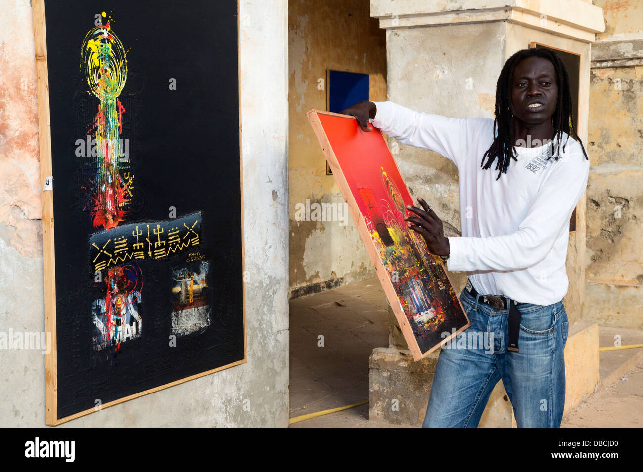 Artist 'Mr. Co' (Corentin Faye) Explains his Painting, Biannual Arts Festival, Goree Island, Senegal. Stock Photo