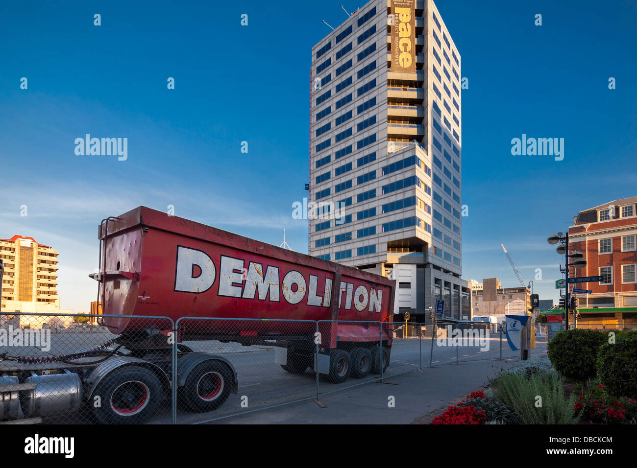 Forsyth Barr Building, 764 Colombo St, Christchurch, New Zealand with demolition truck and fence; cordon. Stock Photo