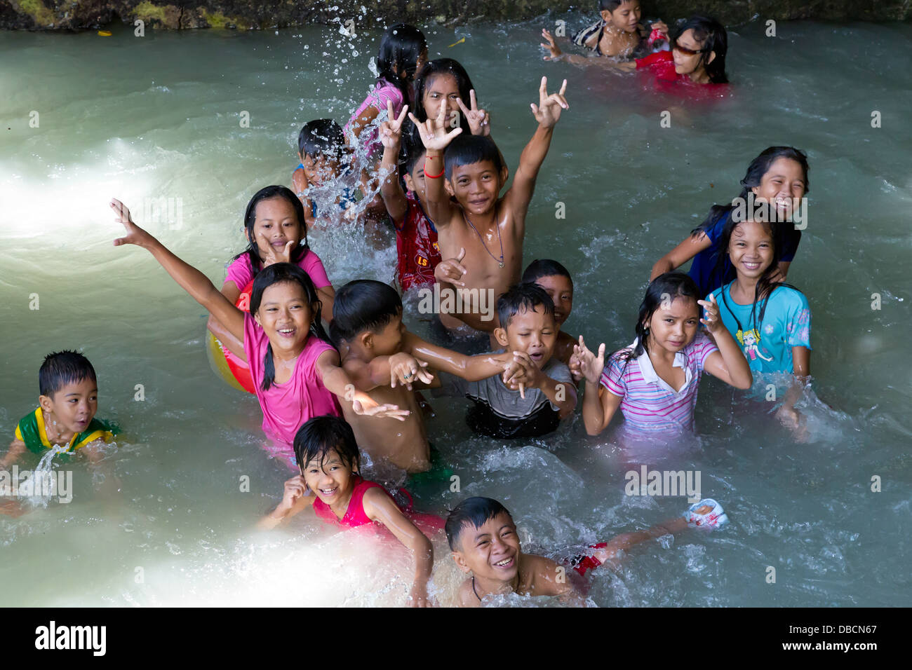 Young local Children enjoying a Bath in a Pool in Tagbilaran on Bohol
