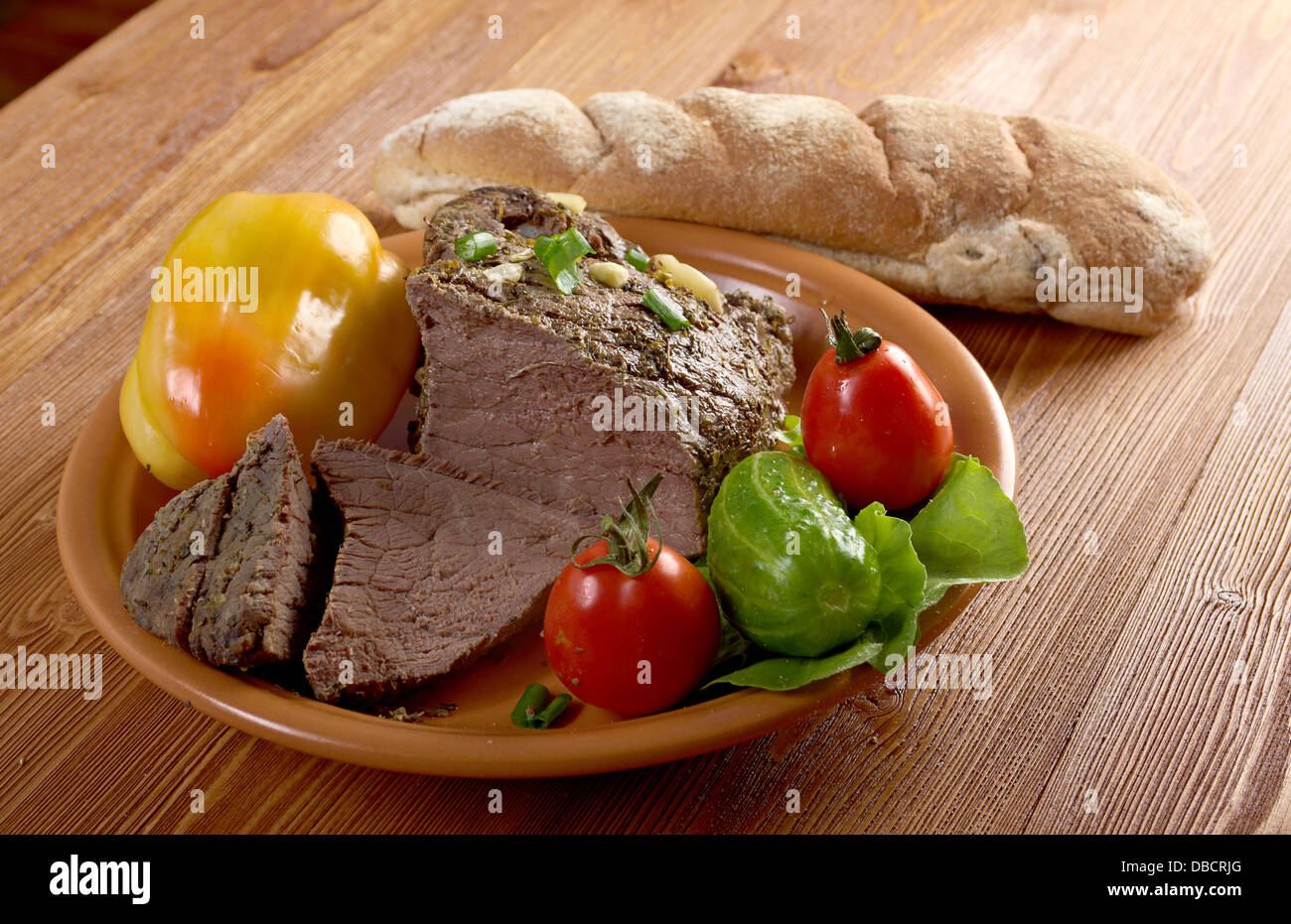 roast beef farm-style with vegetable and bread .farmhouse kitchen Stock Photo