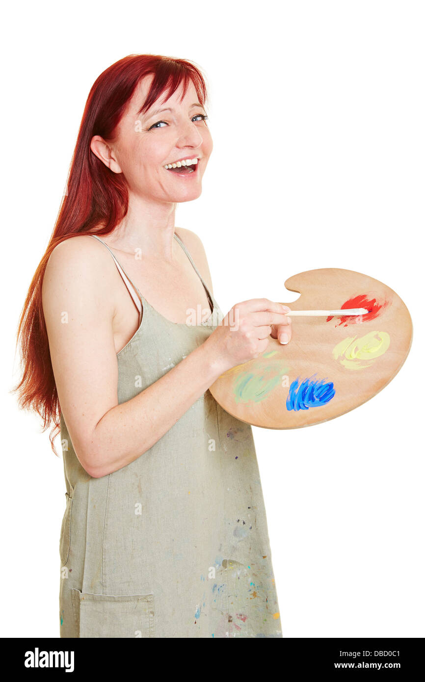 Happy female painter with color mixing palette Stock Photo