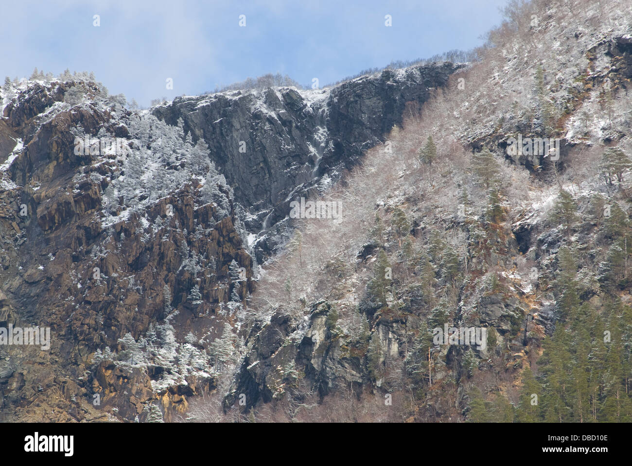 Passing through the narrow Sunnylvs Fjord enroute to Geiranger Fjord on a frosty mid-springtime morning Stock Photo