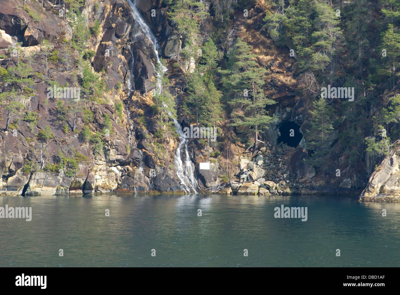Passing through the narrow Sunnylvs Fjord enroute to Geiranger Fjord on a frosty mid-springtime morning Stock Photo