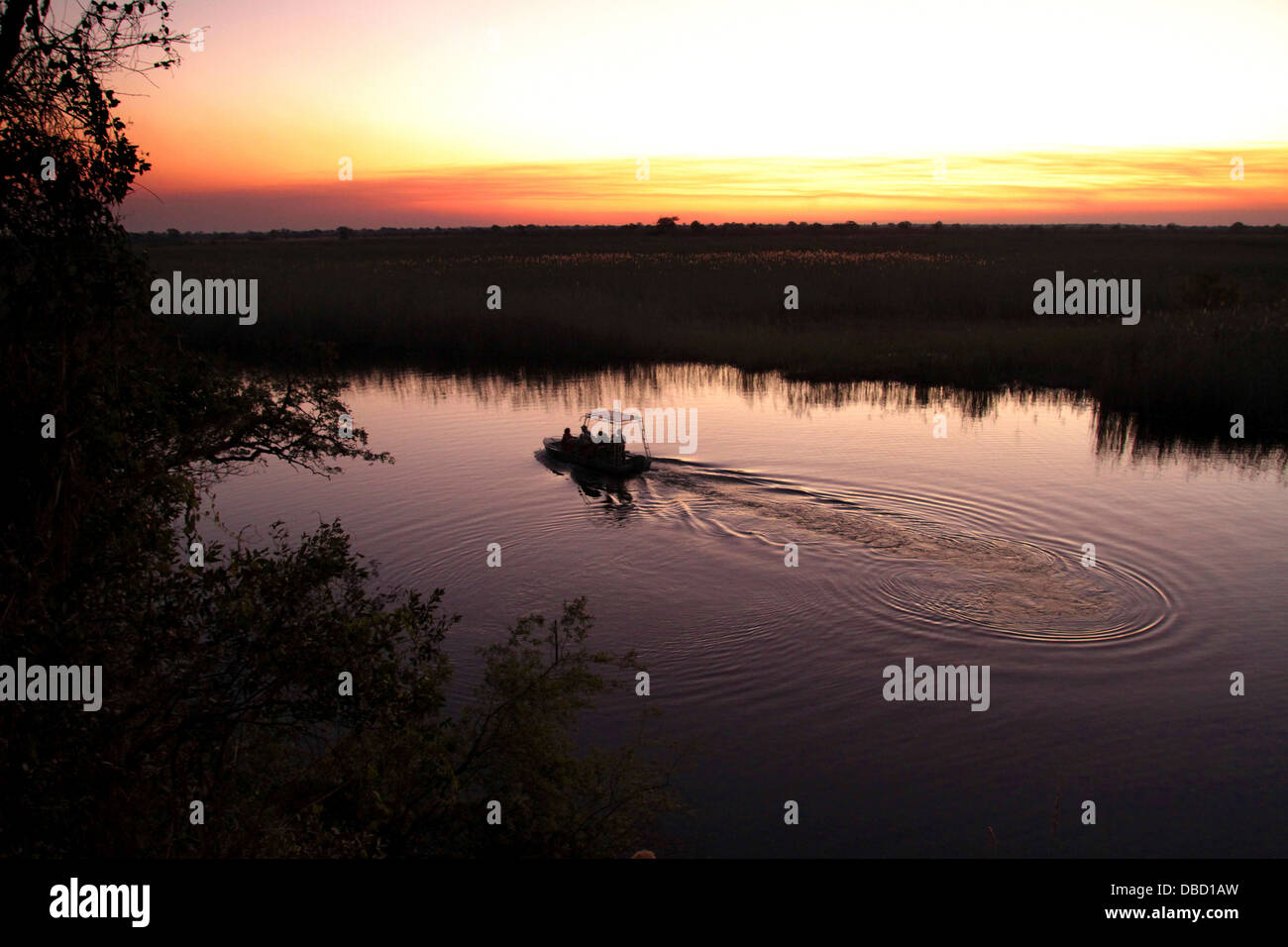 Game Viewing on the Kwando River at sunset. Stock Photo