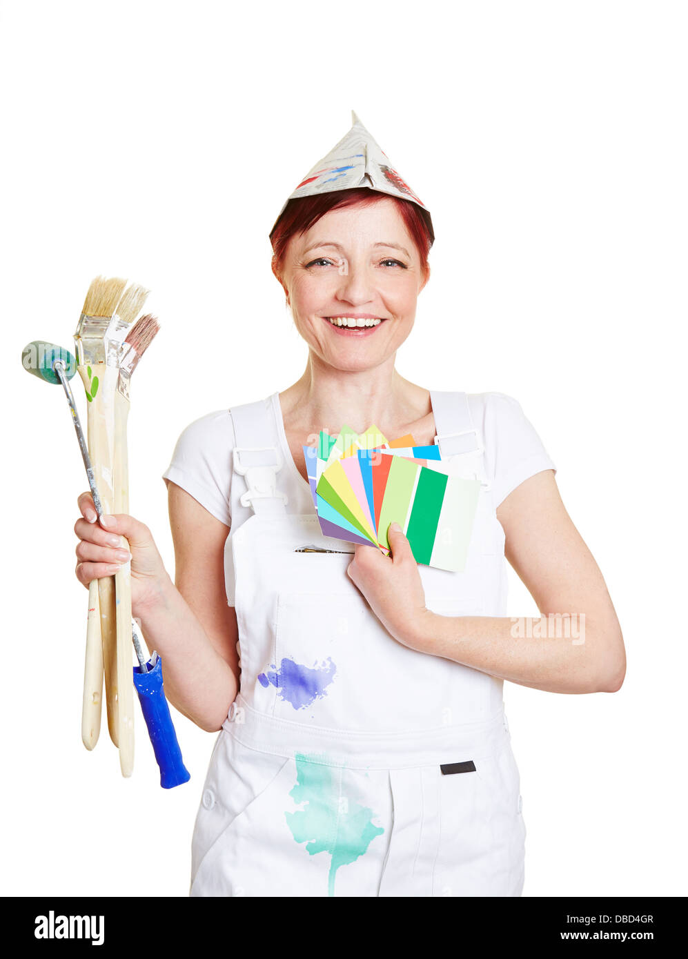 Happy woman in painter overall with brushes and color fan Stock Photo