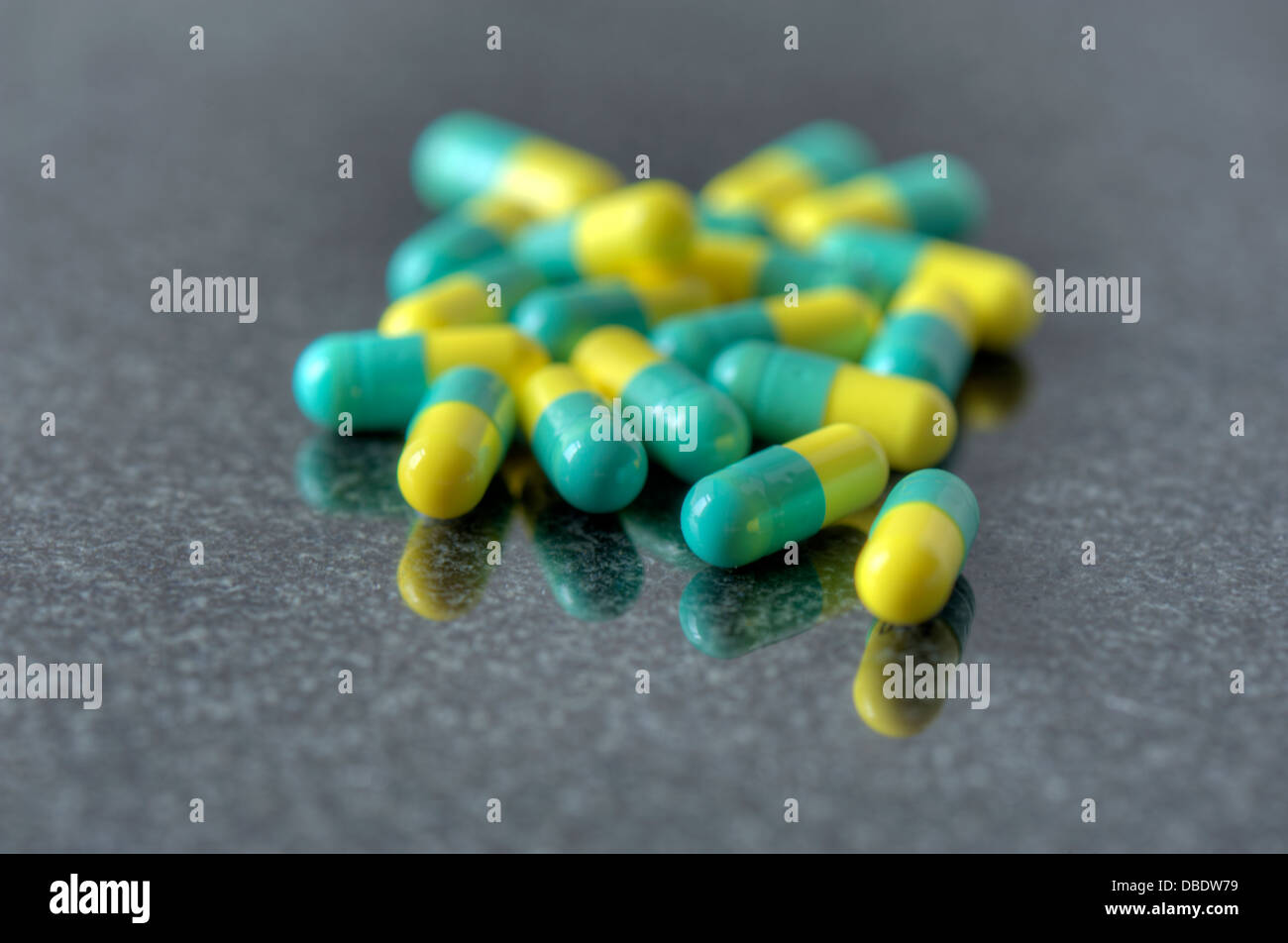Close-up of prescription drugs - green/yellow capsules Stock Photo