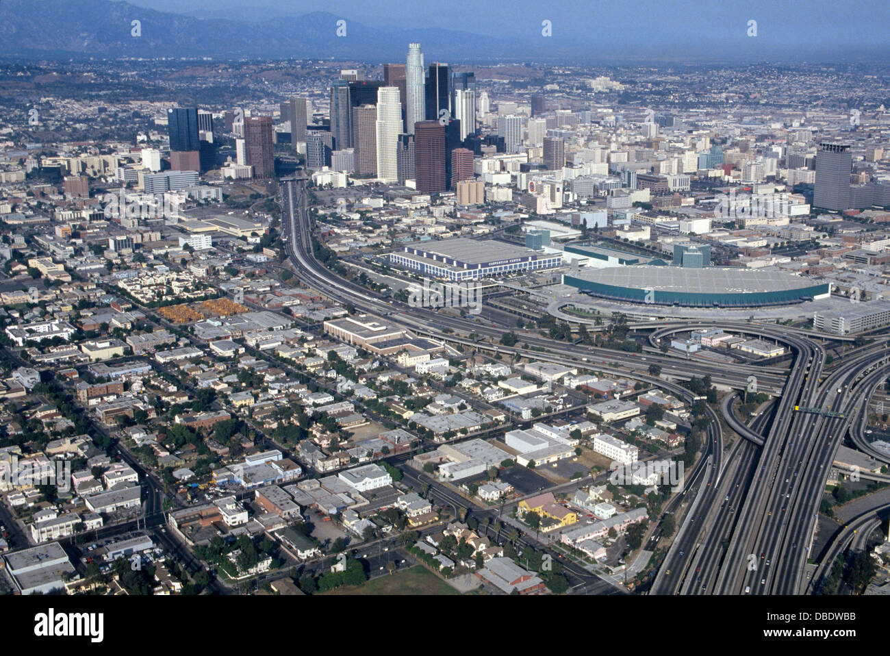 An aerial view shows freeways flowing past the vast Los Angeles Convention Center (foreground) and into downtown Los Angeles, California, USA. Stock Photo