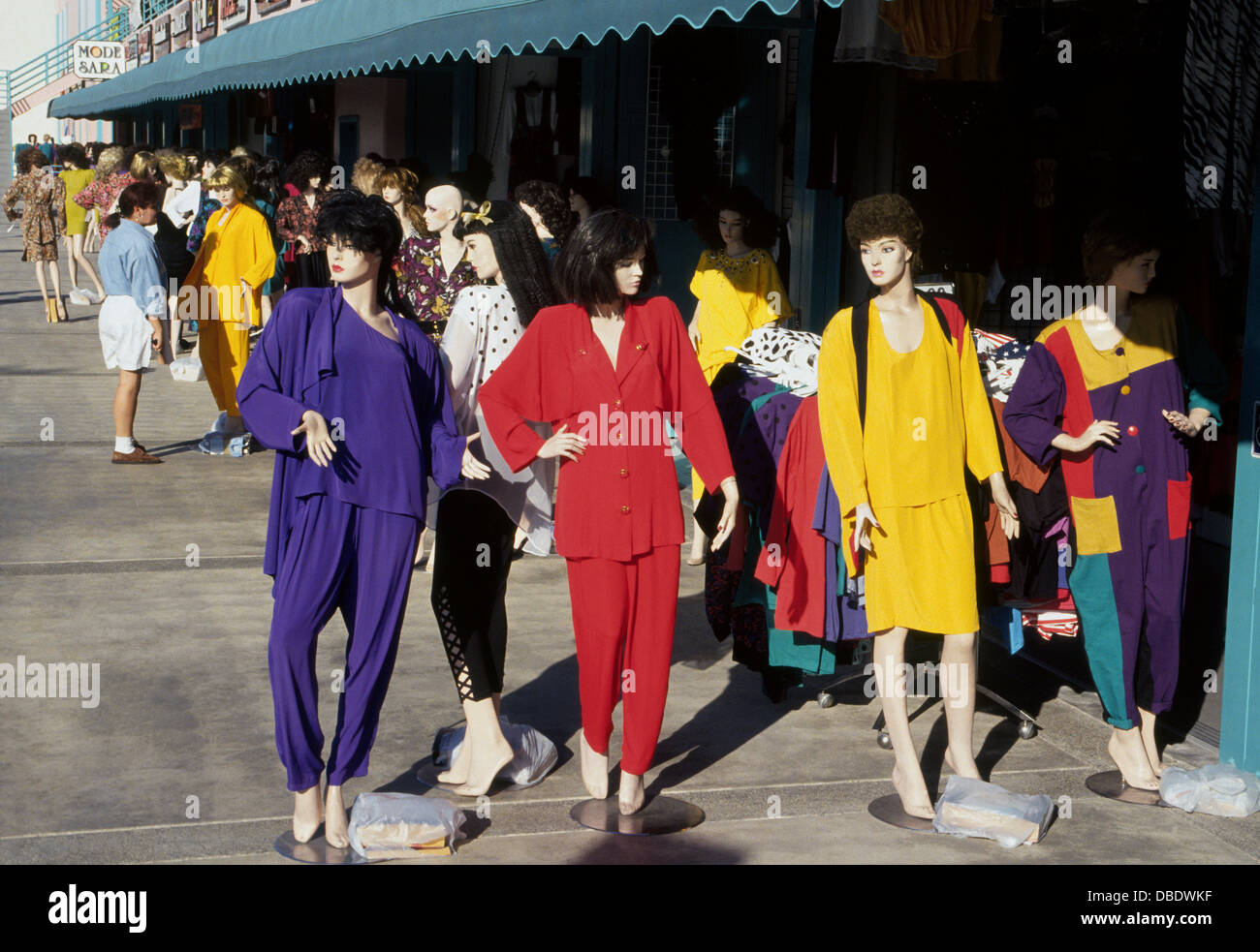 Colorful mannequins dressed in various fashions decorate the sidewalks