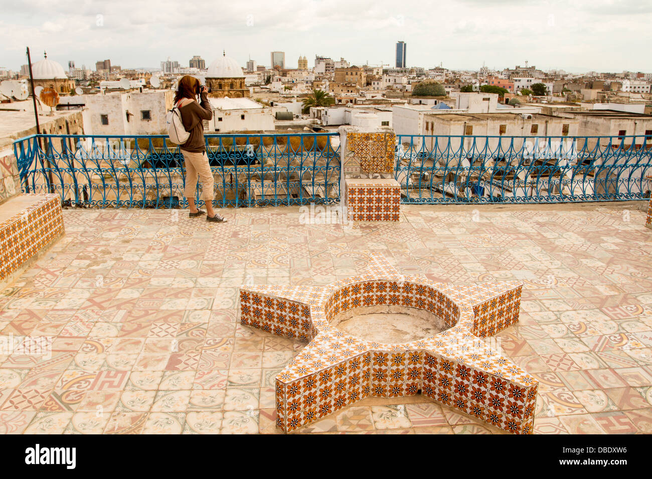 A tourist taking photos of the Medina of Tunis, from a viewer on the roofs of the bazaar, Tunisia. Stock Photo