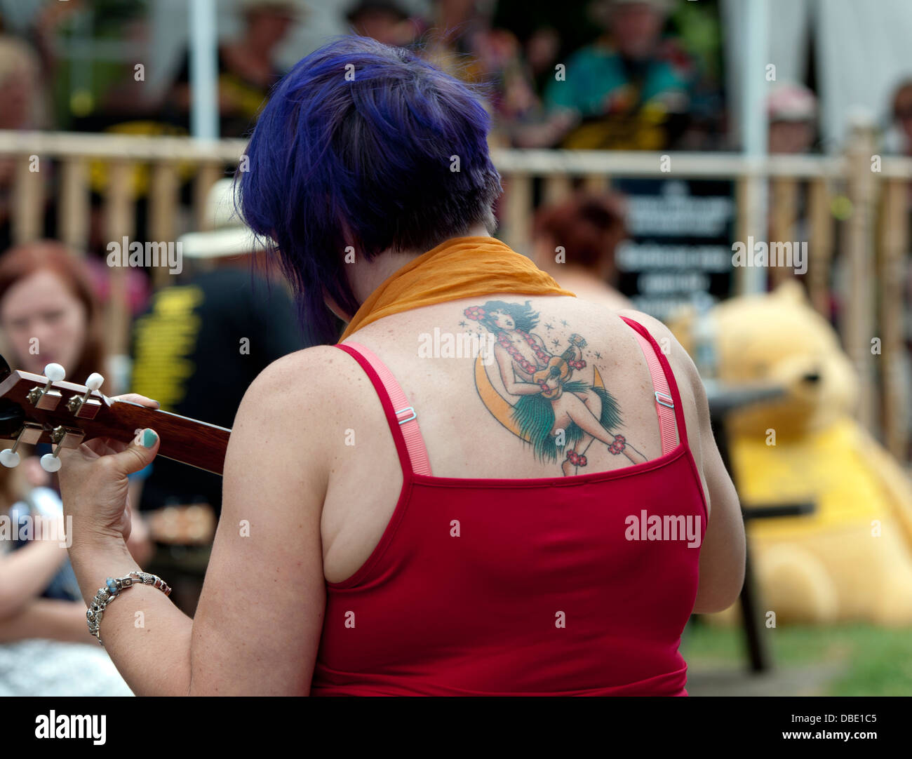 Ukulele player tattoo on a woman`s back Stock Photo - Alamy