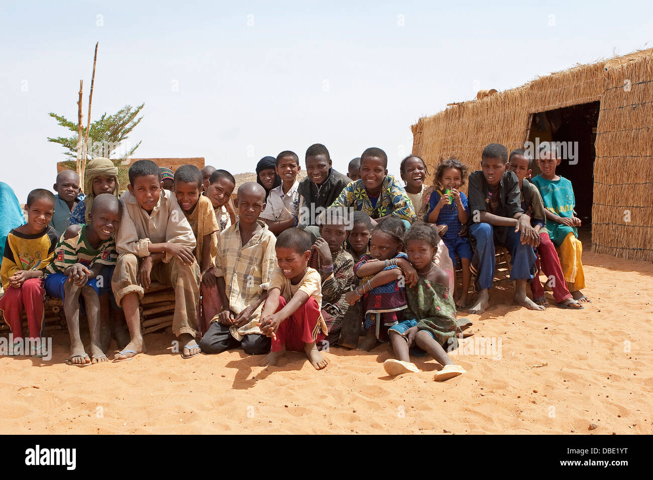 Group of Tuareg school children outside their school building in the village compound from north east Mali, West Africa Stock Photo