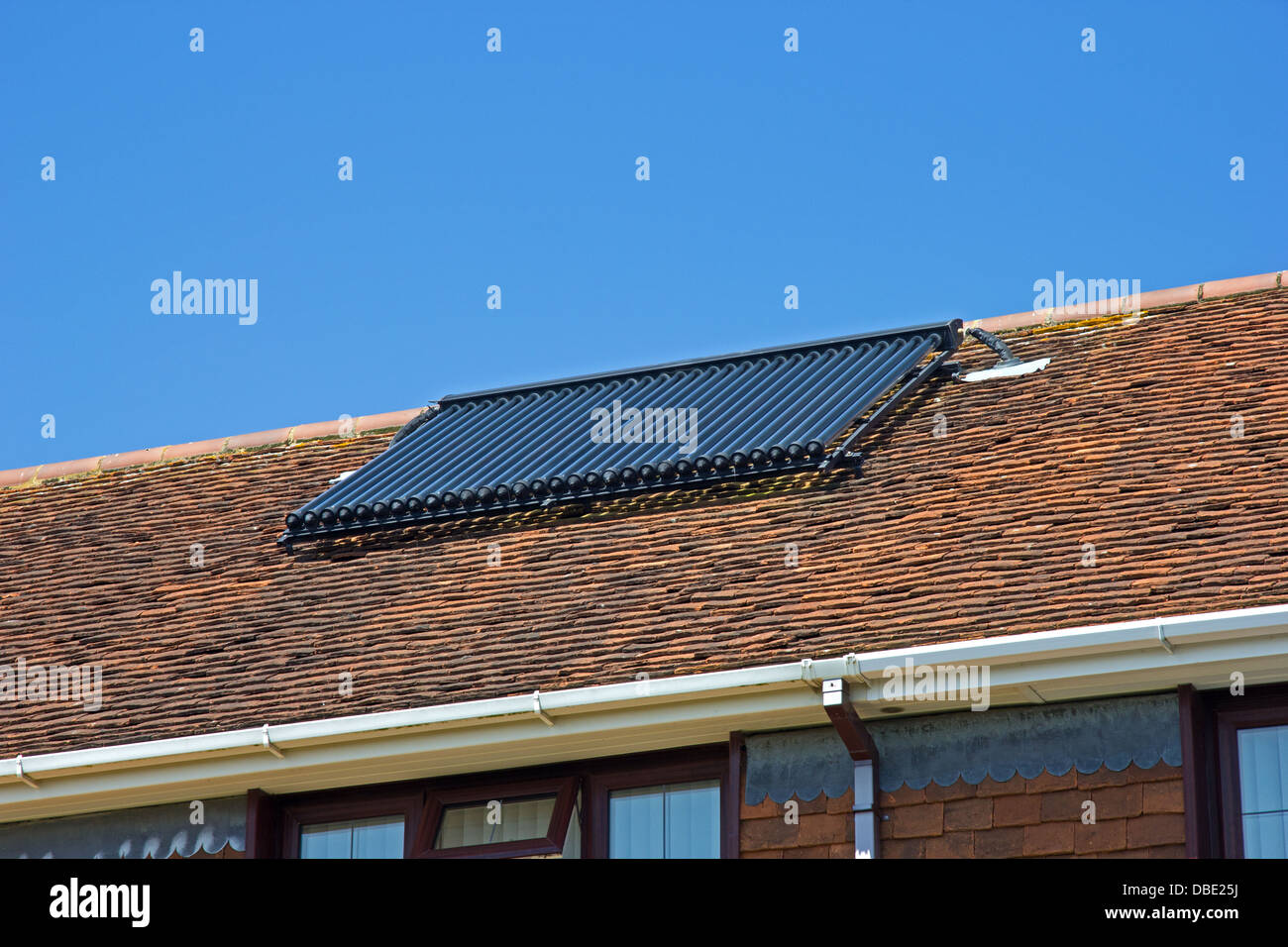 Solar water heating panel on house roof Stock Photo