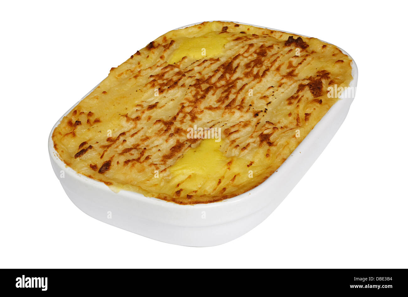 Traditional Homemade Fish Pie in a casserole dish with crispy mashed potatoes on the top Stock Photo