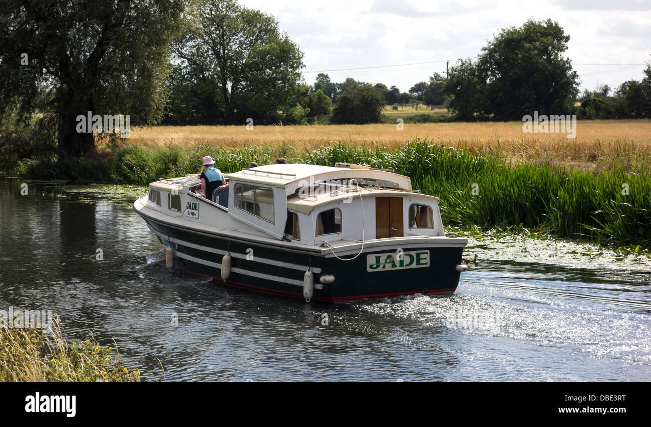 River cruiser Jade heading downstream on the river Cam Milton Cambridgeshire England Stock Photo