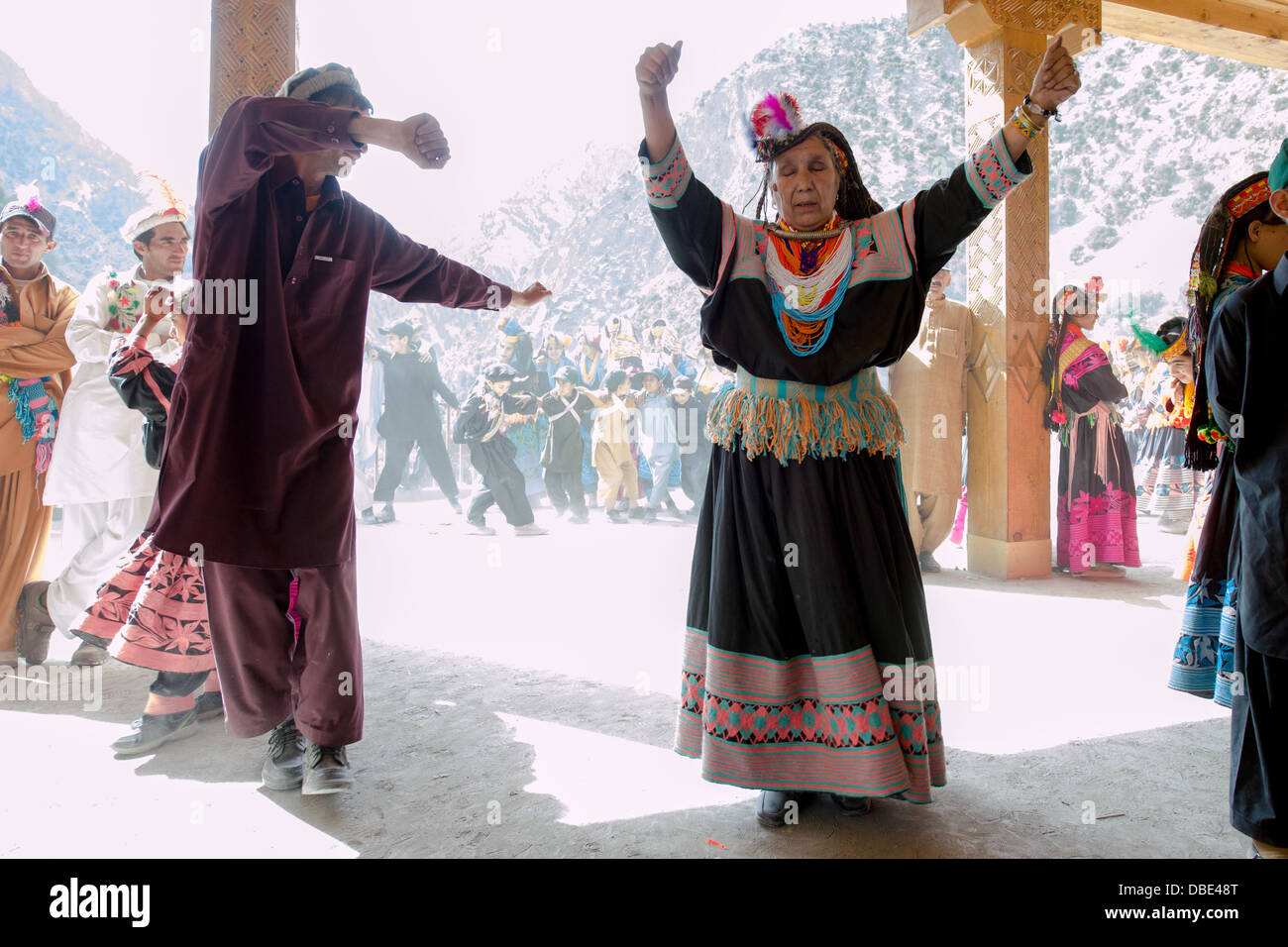 Kalash man and elder woman dancing at the Kalash Joshi (Spring Festival), Grum Village Charso (dancing ground), Rumbur Valley, Chitral, Khyber-Pakhtunkhwa, Pakistan Stock Photo