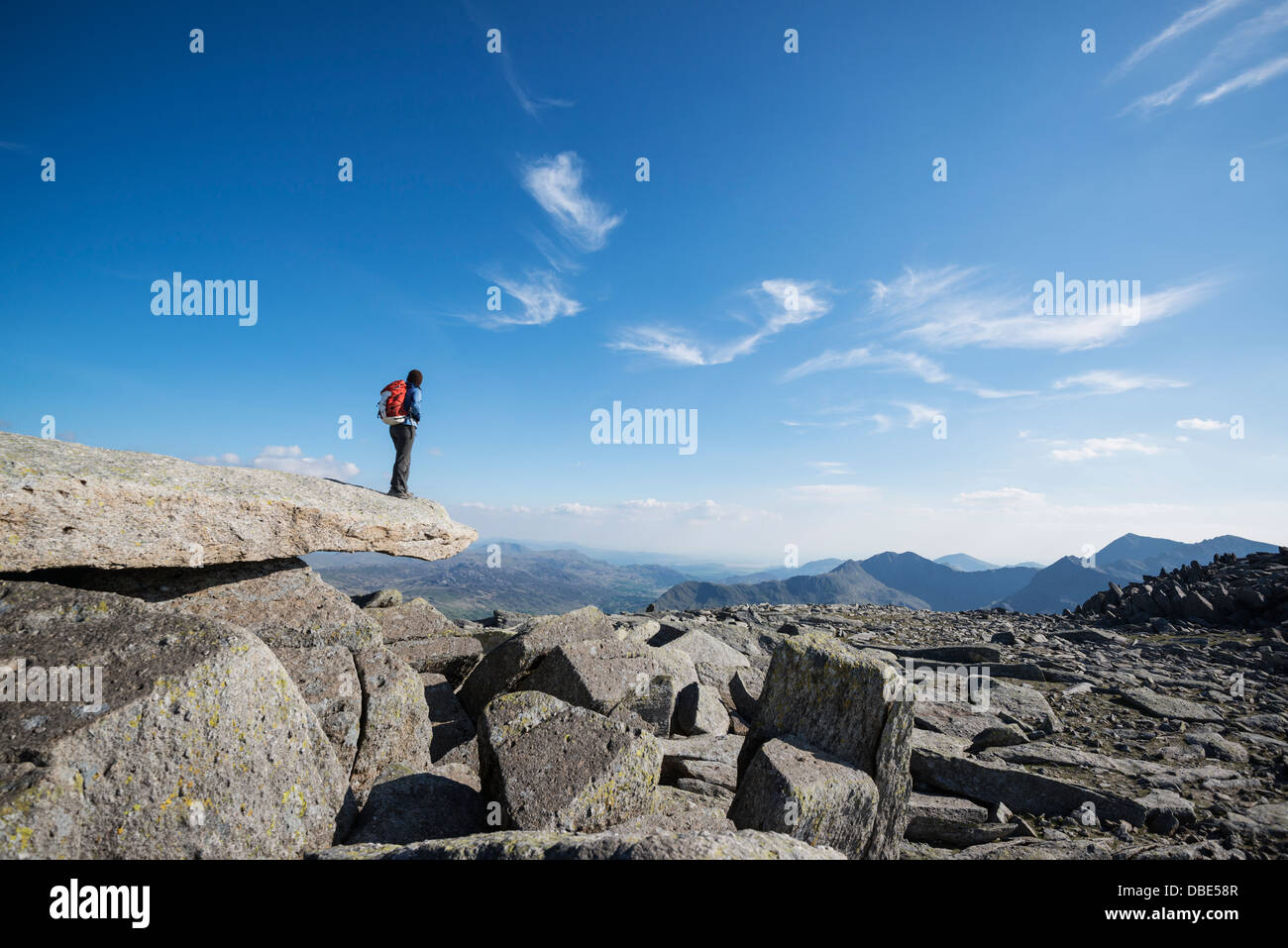 Female hiker on Cantilever stone, Glyder Fach, Snowdonia national park, Wales Stock Photo