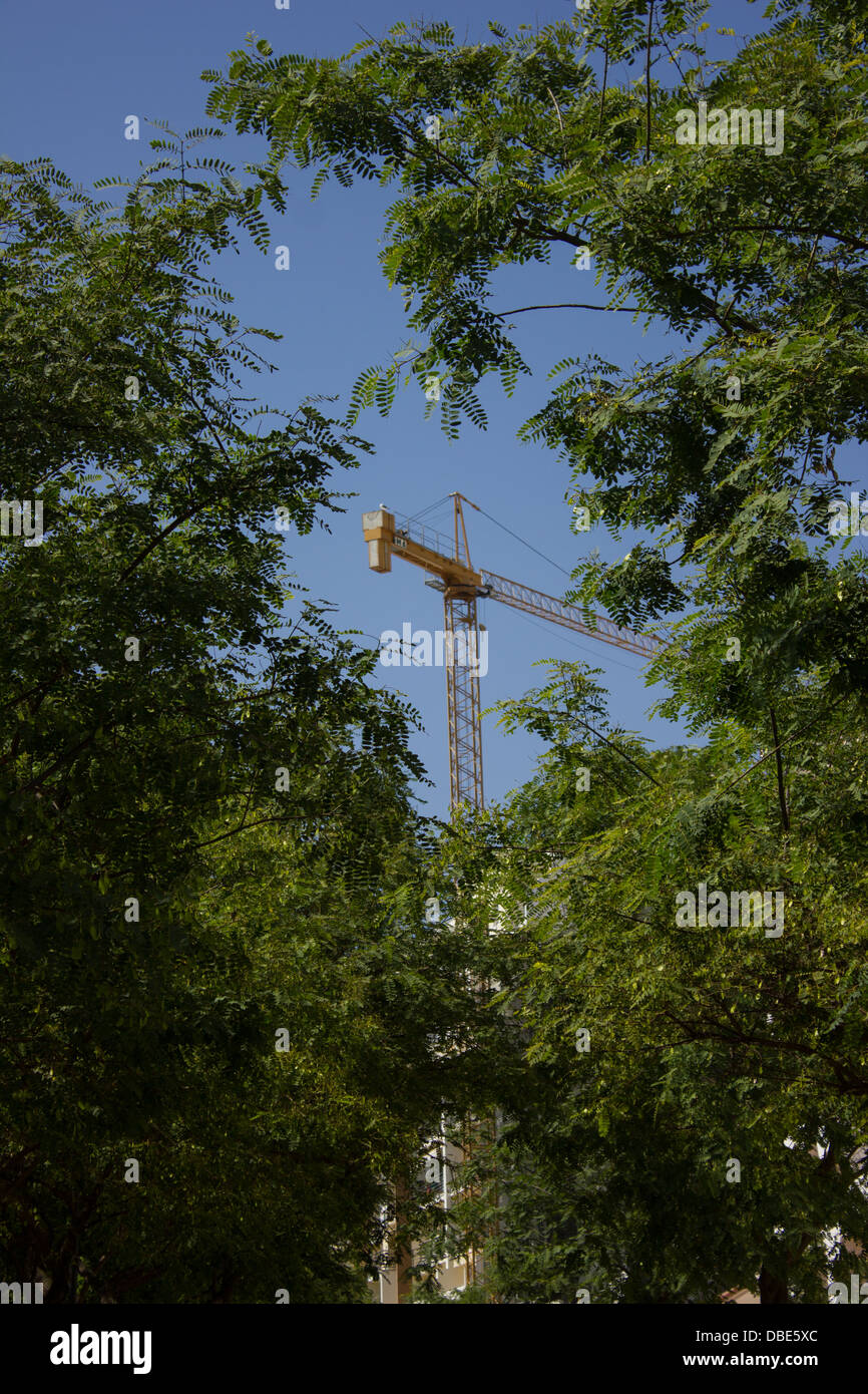 Crane between green trees Stock Photo