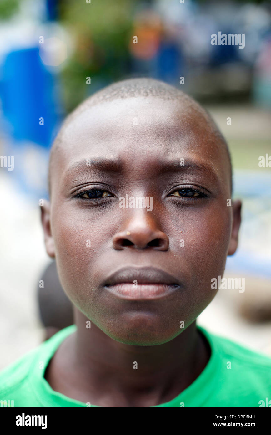 A young boy hangs out outside of the Petionville police station in Port au Prince, Haiti Stock Photo