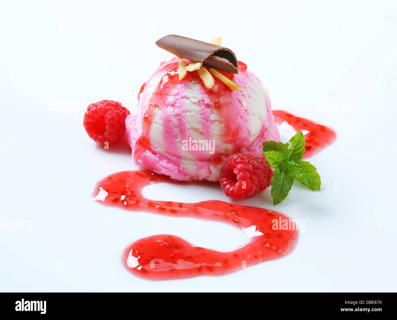 Scoop of raspberry ice cream with syrup Stock Photo - Alamy