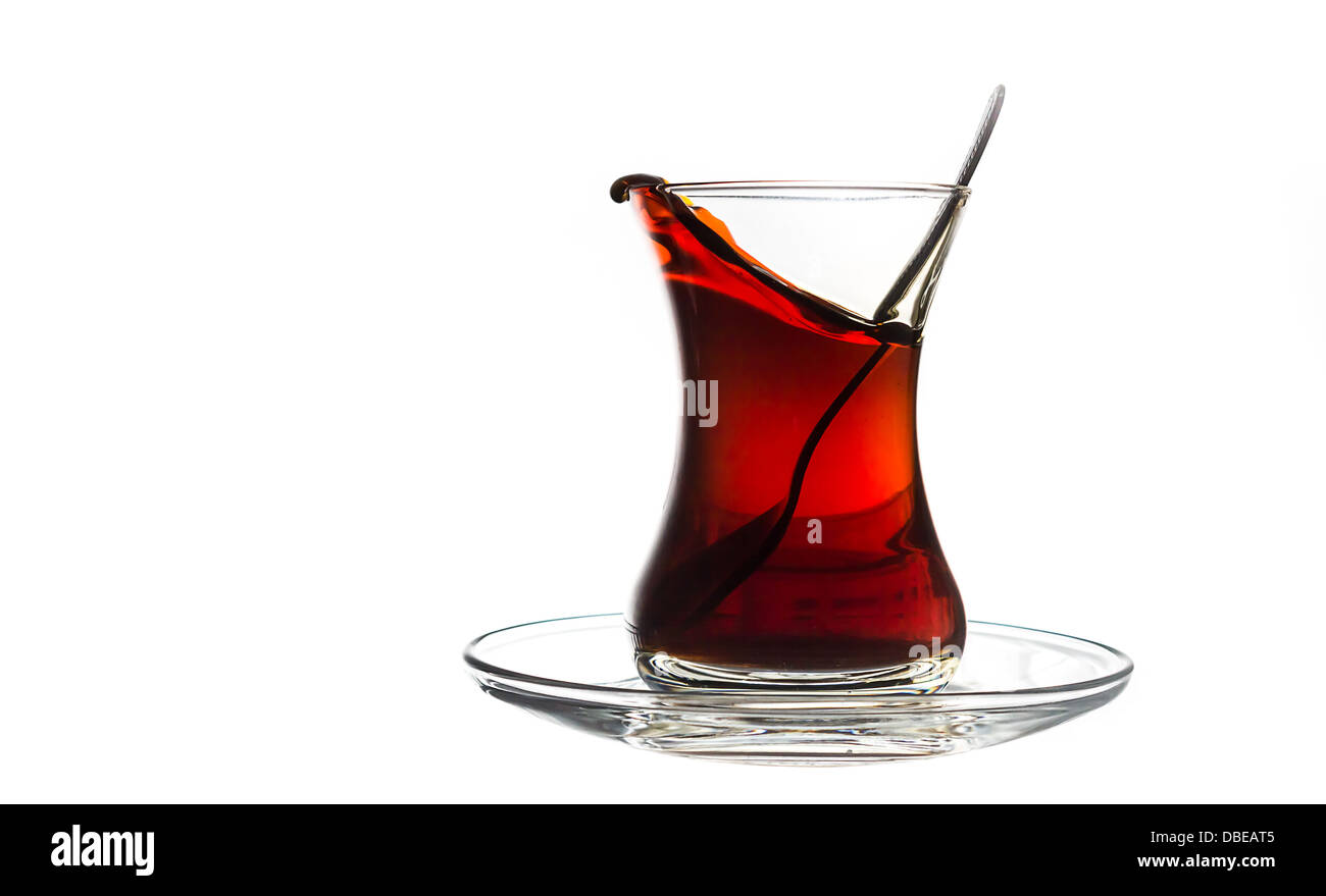 Turkish tea on white background just before spilling. Stock Photo