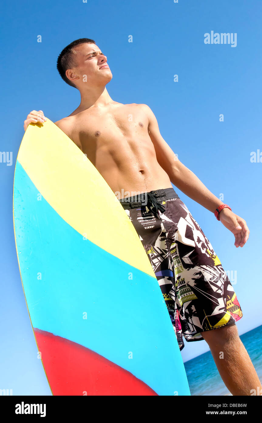 Handsome surfer posing in the beach Stock Photo - Alamy