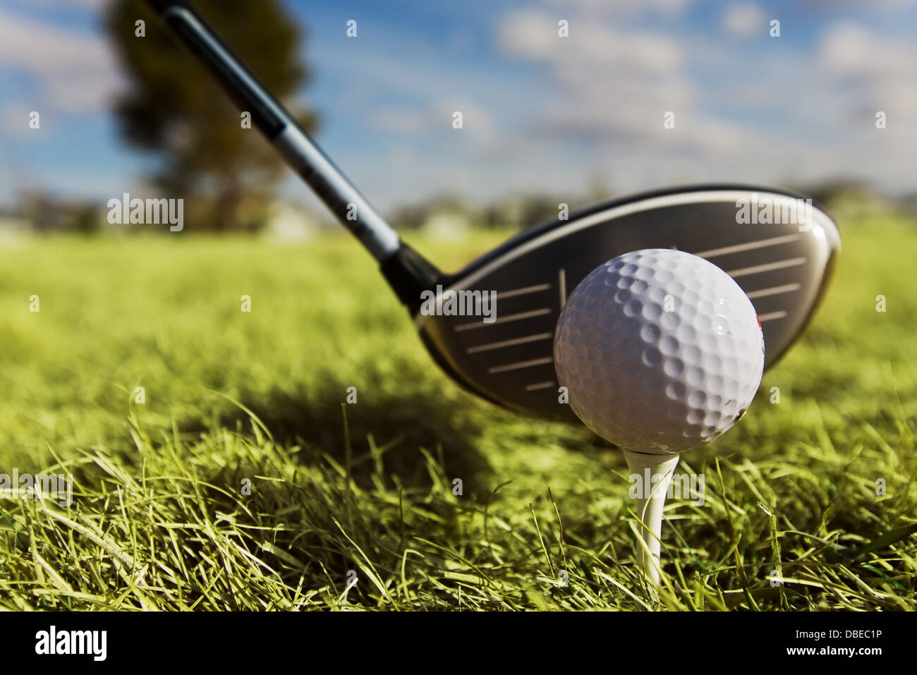A golf ball and left handed driver with main focus on the ball Stock