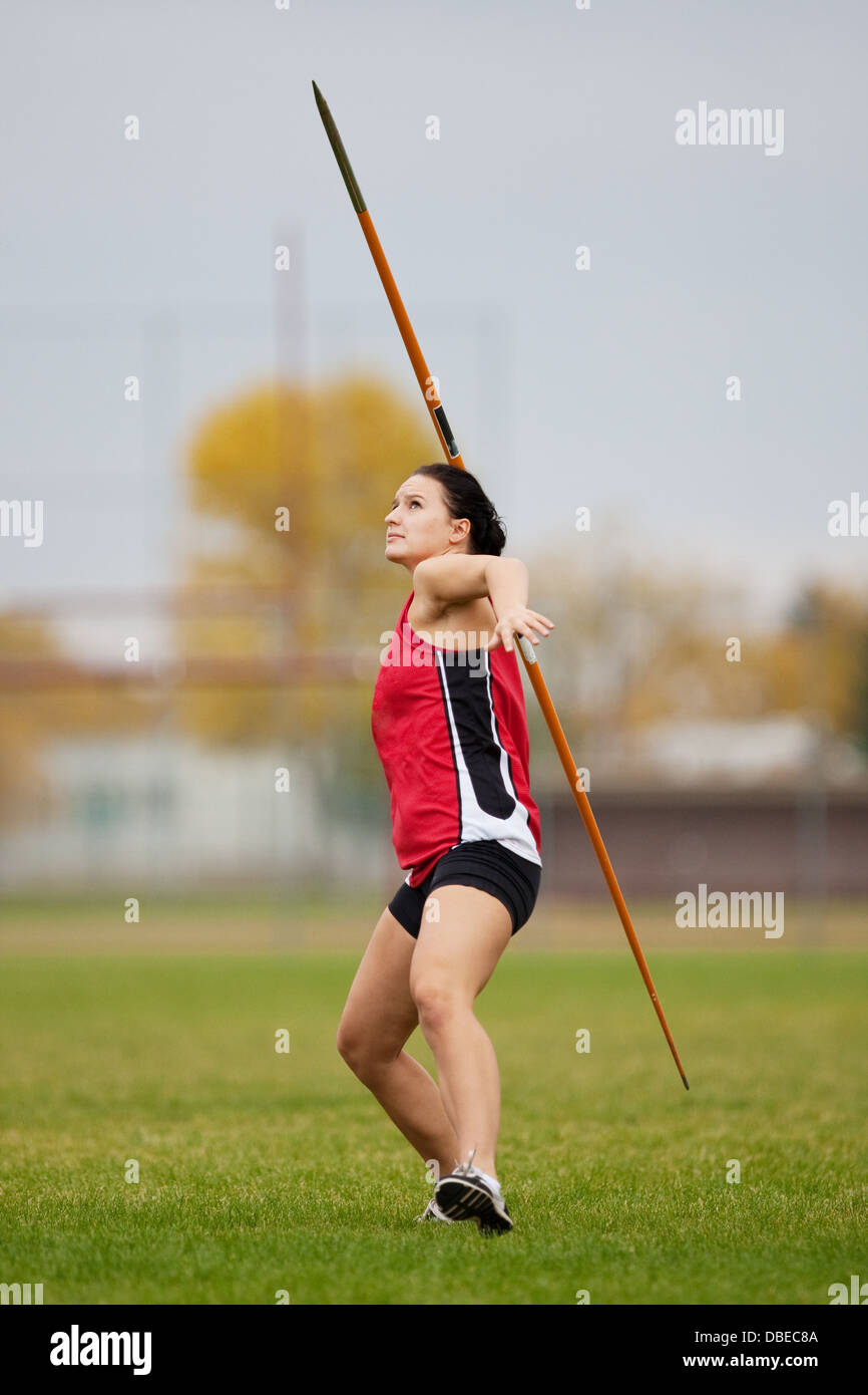 Female athlete throwing a javelin at a track and field sports event Stock Photo
