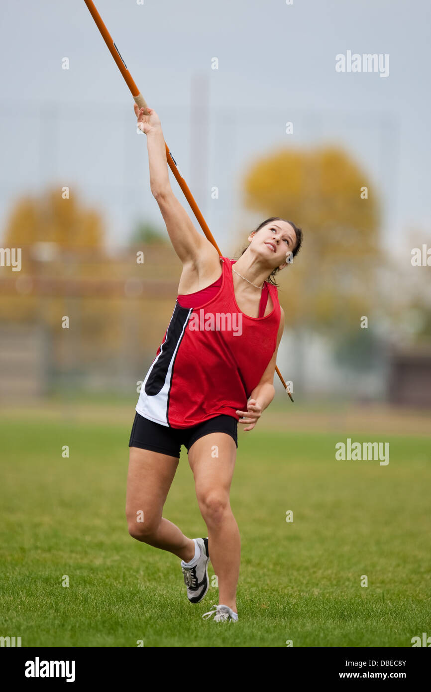 Female athlete throwing a javelin at a sports event Stock Photo