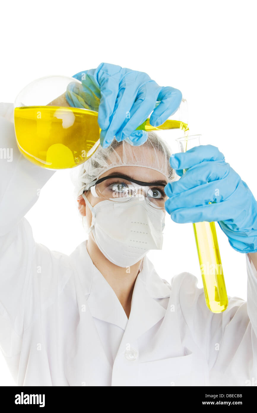 A professional lab worker pouring yellow liquid into a test tube Stock Photo
