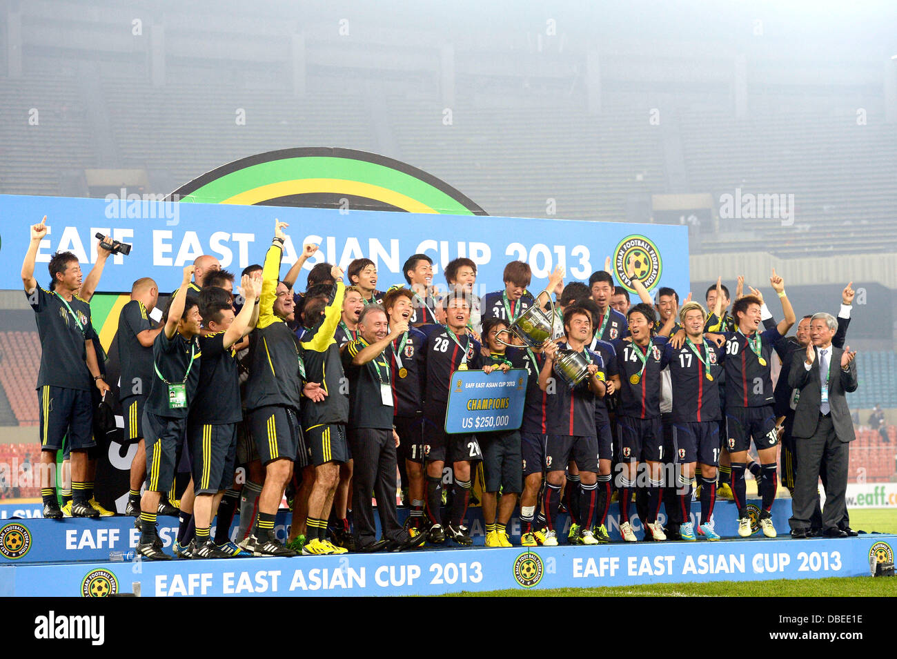 Japan players celebrate winning their title with the trophy