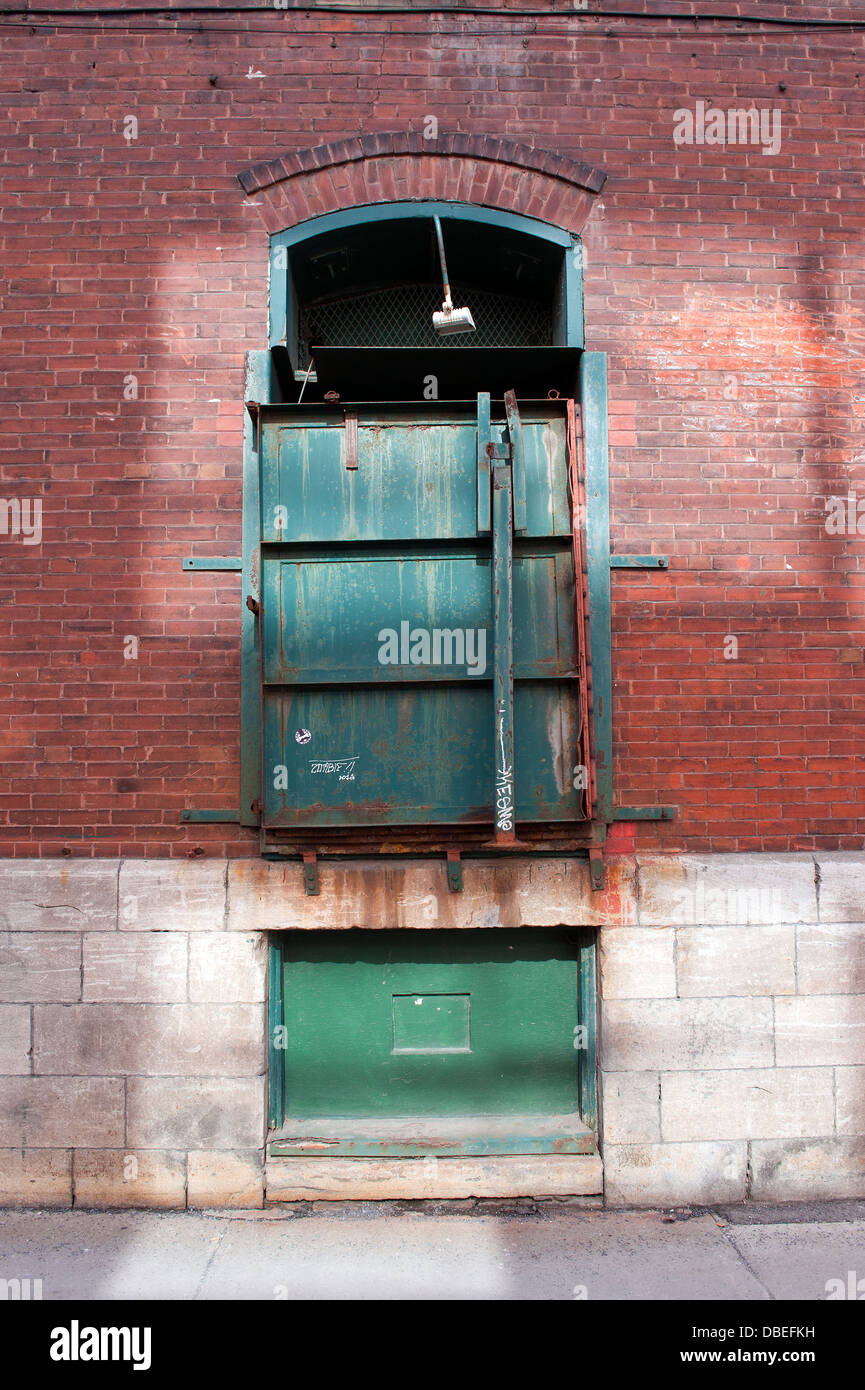 Green loading dock, old industrial building. Stock Photo
