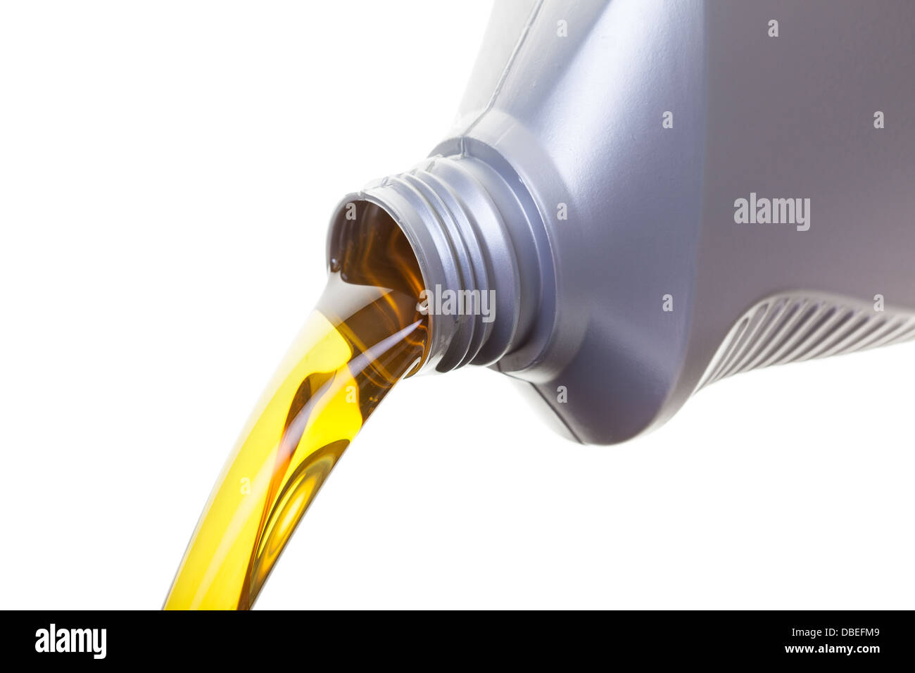 Pouring oil from a jug, shot on a whit background Stock Photo