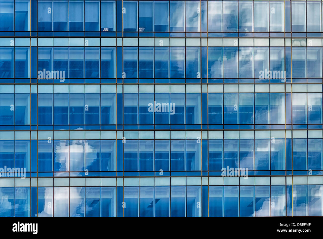 A city abstract image.Clouds reflection in a architectural grid of a modern building Stock Photo