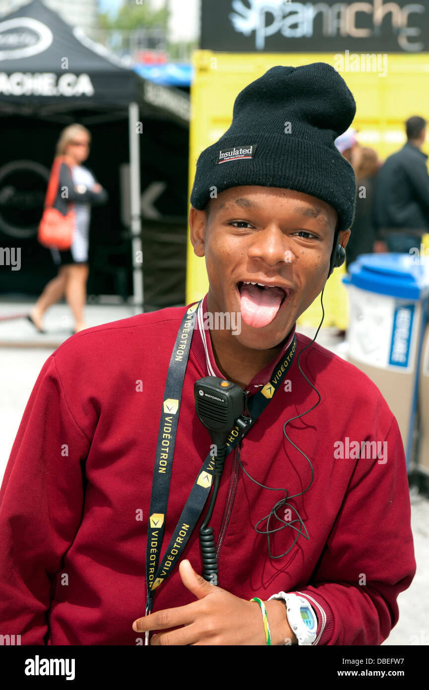 Teenager playfully pulling his tongue at photographer Stock Photo Alamy