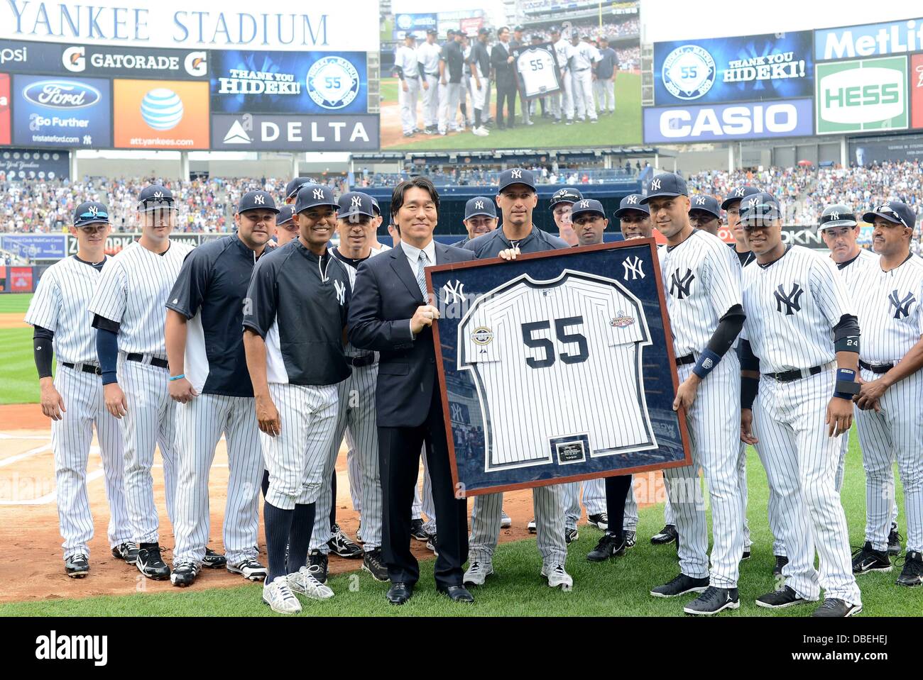 The Bronx, New York, USA. 28th , 2013. Hideki Matsui MLB : Hideki Matsui  poses with a framed number 55 jersey and New York Yankees players after  receiving it from Derek Jeter