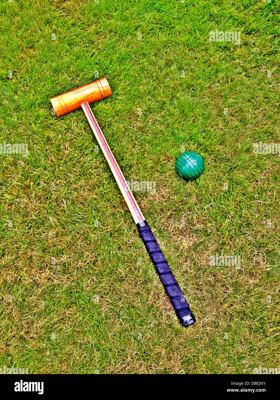 Croquet ball and mallet on green lawn Stock Photo Alamy