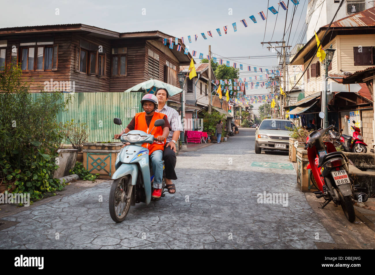 Unidentified man on a motorbike in the Thai capital Stock Photo