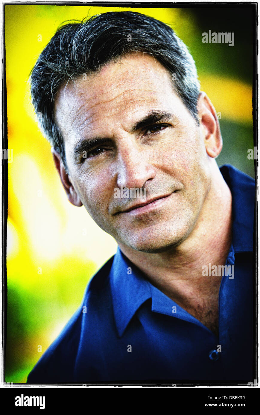 Smiling man standing outdoors - Smartphone Captured Stock Image