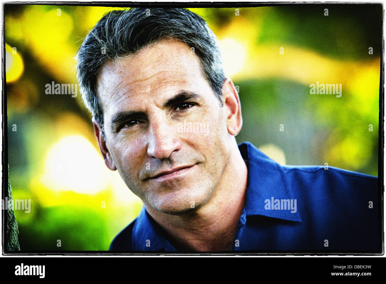 Smiling man standing outdoors - Smartphone Captured Stock Image