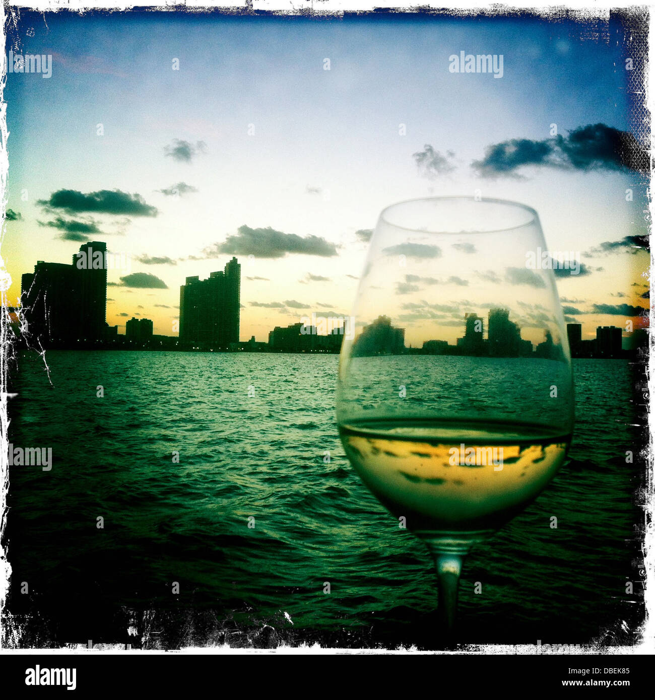 Glass of wine and urban skyline, Miami, Florida, United States Stock Photo