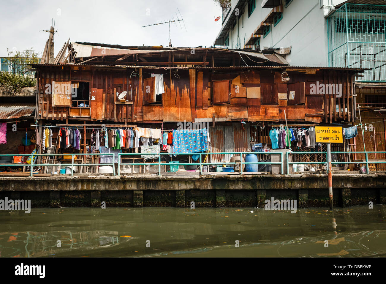 Slum on dirty canal in Bangkok, Thailand Stock Photo