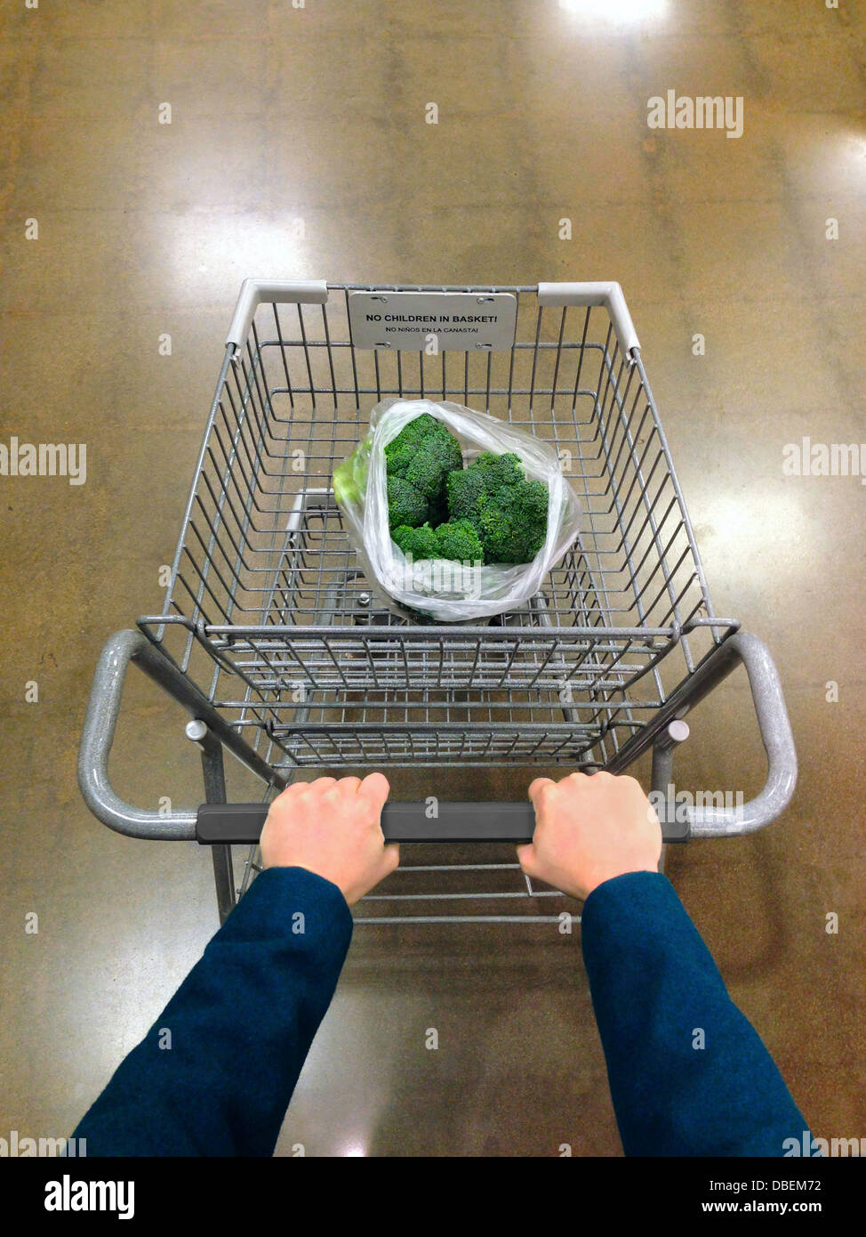 Caucasian man pushing grocery cart with broccoli - Smartphone Captured Stock Image