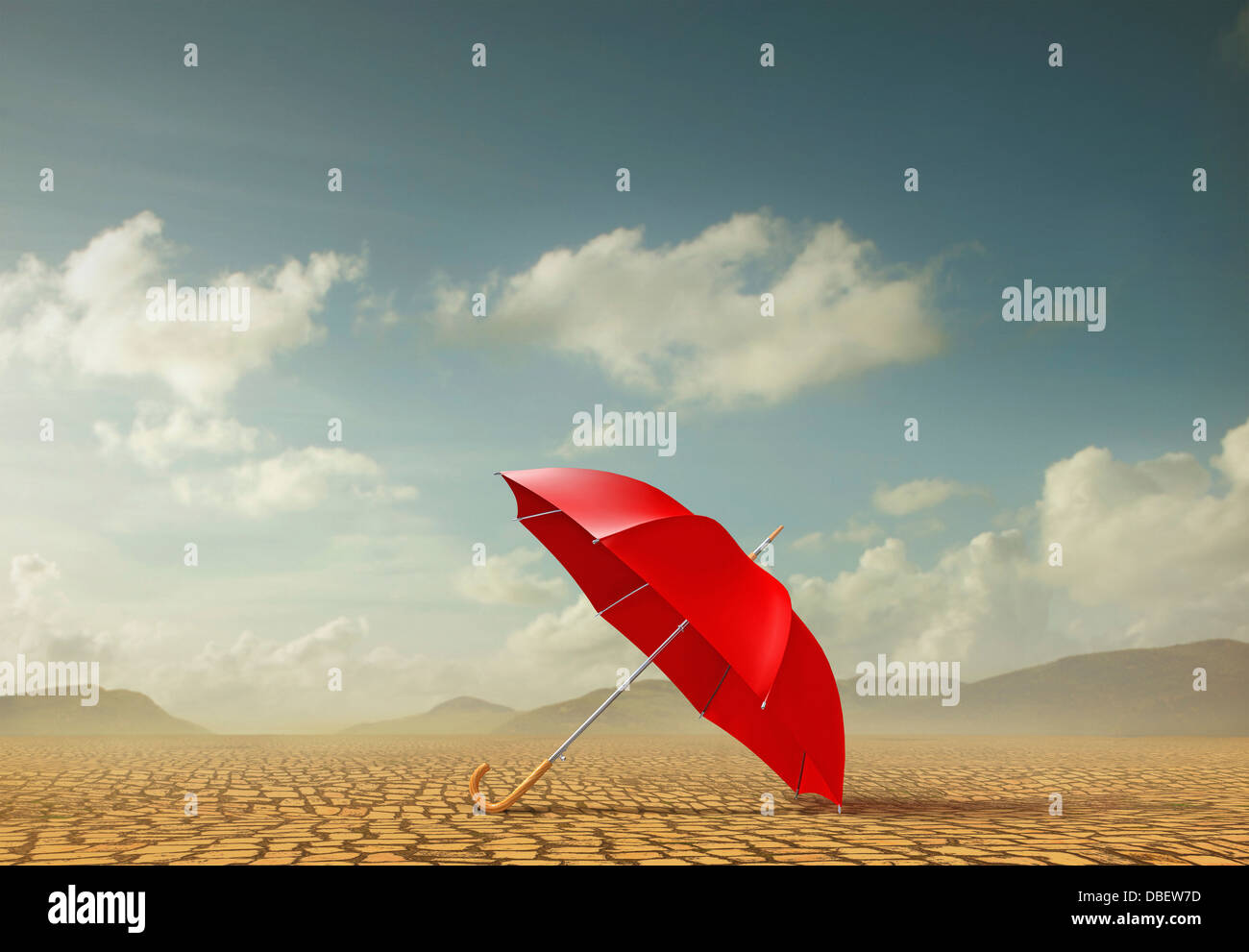 Red umbrella in desert landscape Stock Photo