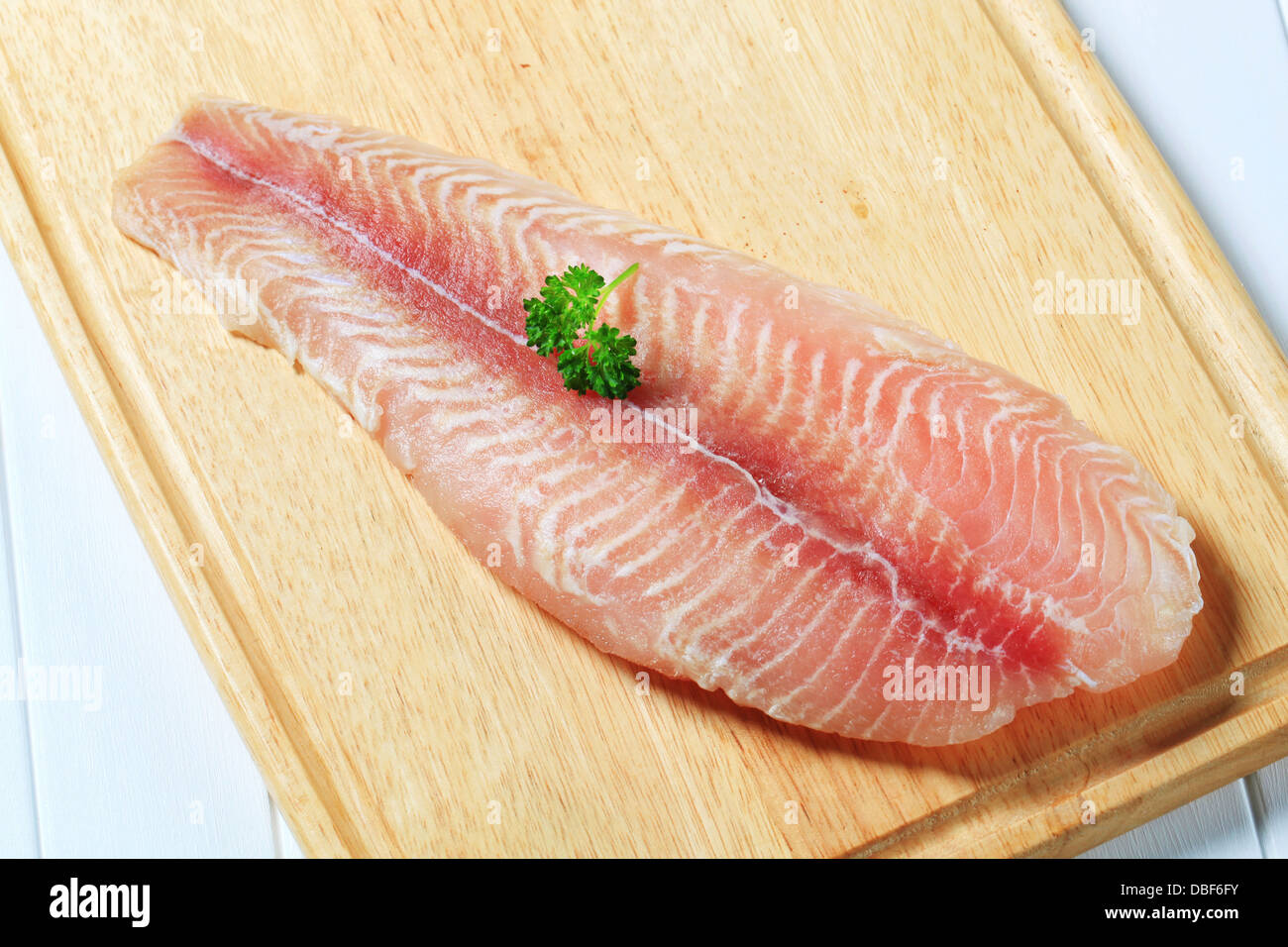 Frozen catfish fillet on cutting board Stock Photo Alamy