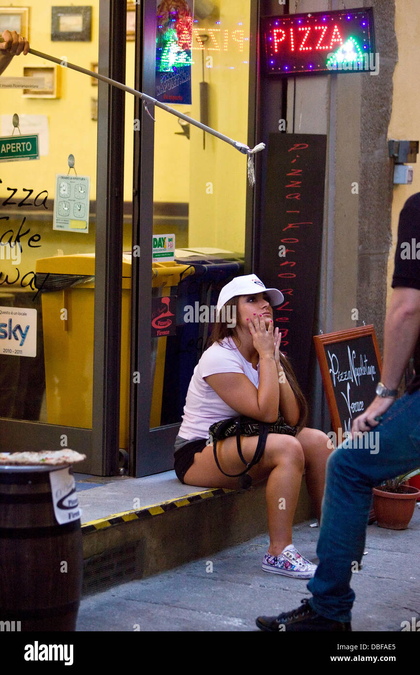 Deena Nicole Cortese Deena was desperately trying to leave work at the Pizzeria as soon as possible to get ready to go out and party at Grand Central Night Club. Ronnie was sat with her outside for a bit drinking beer whilst Deena was supping on an ice-te Stock Photo
