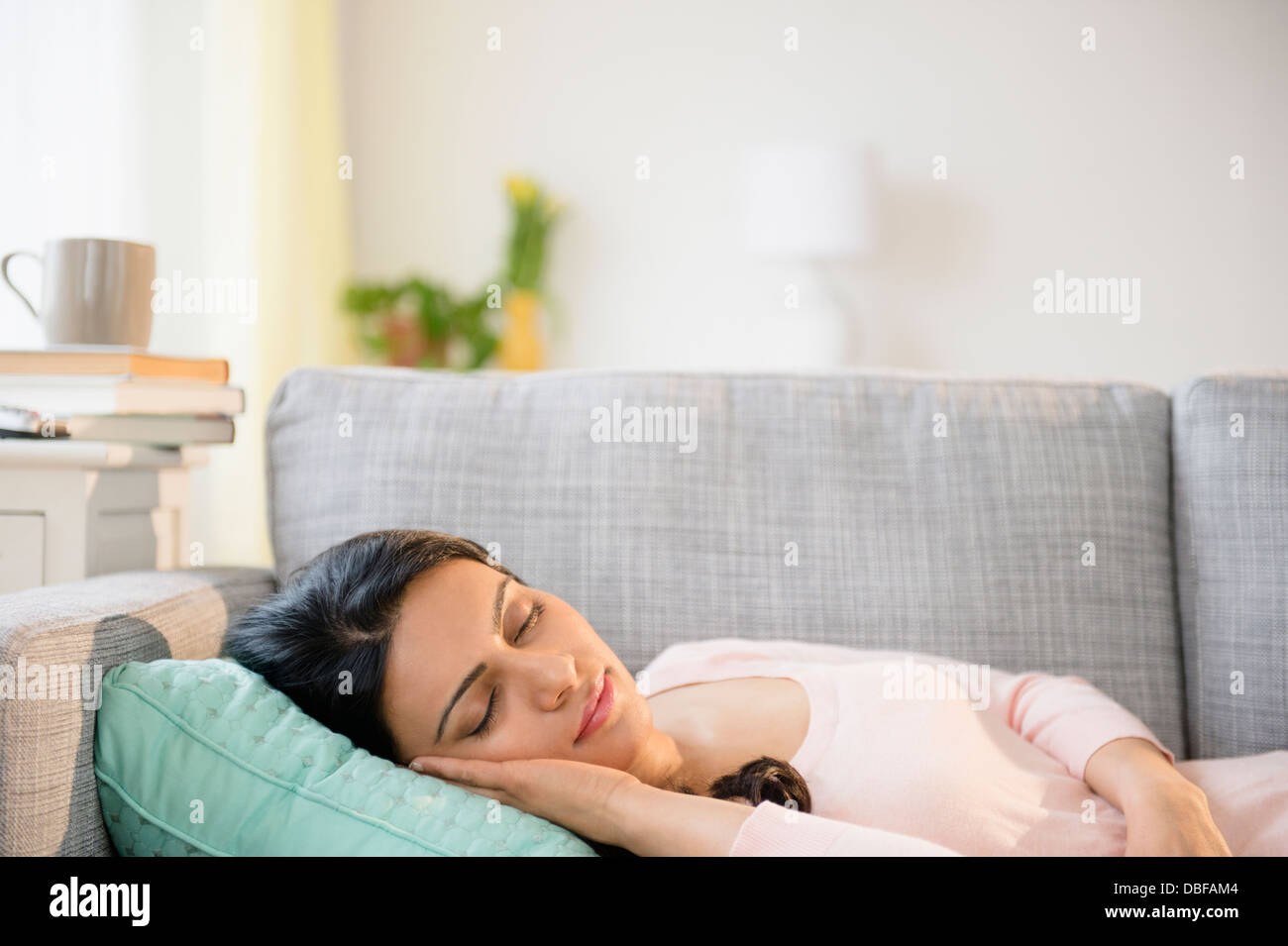 Indian woman napping on sofa Stock Photo
