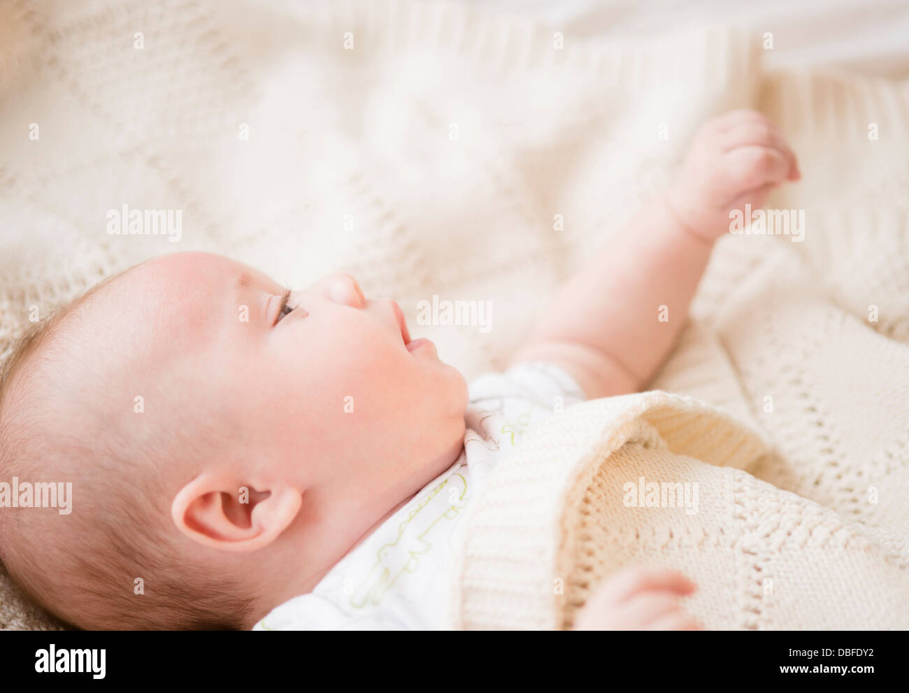 Caucasian baby laying on bed Stock Photo Alamy