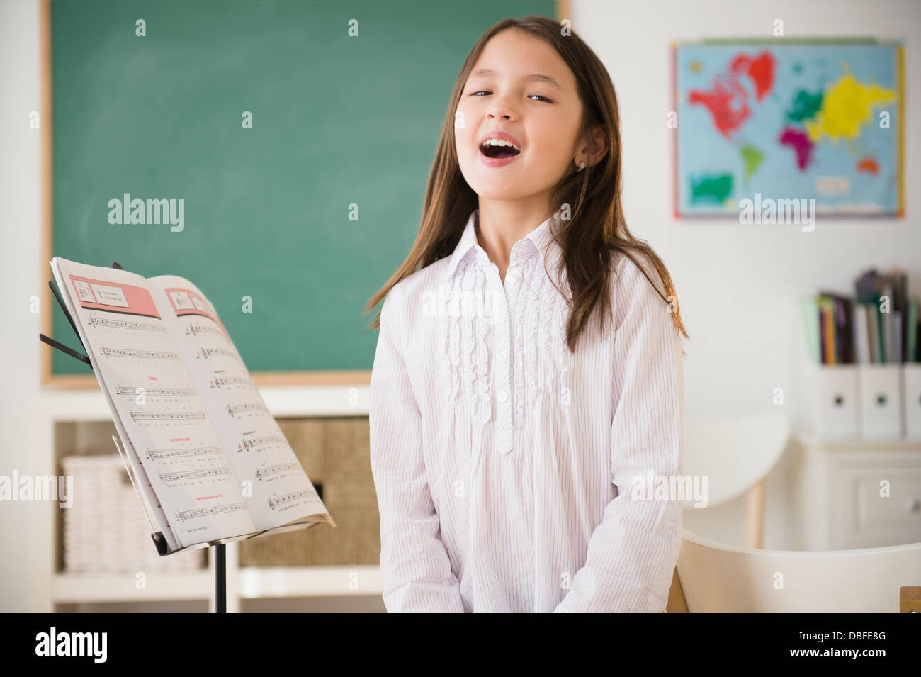 Mixed race girl in singing class Stock Photo