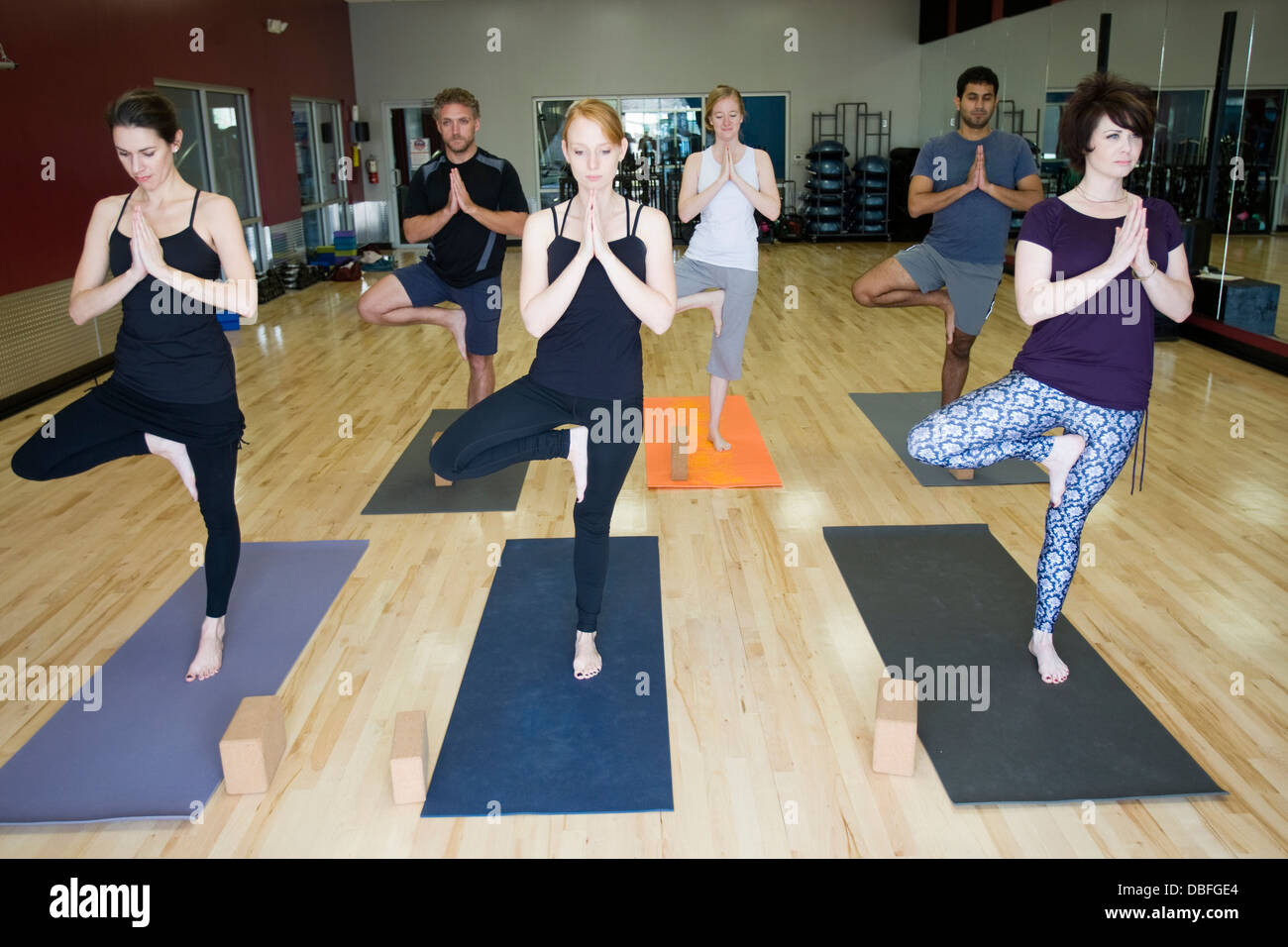 People practicing yoga in class Stock Photo