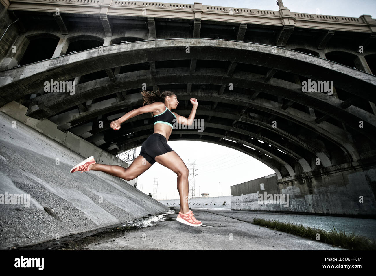 Surpass Running African American runner under overpass Stock Photo - Alamy